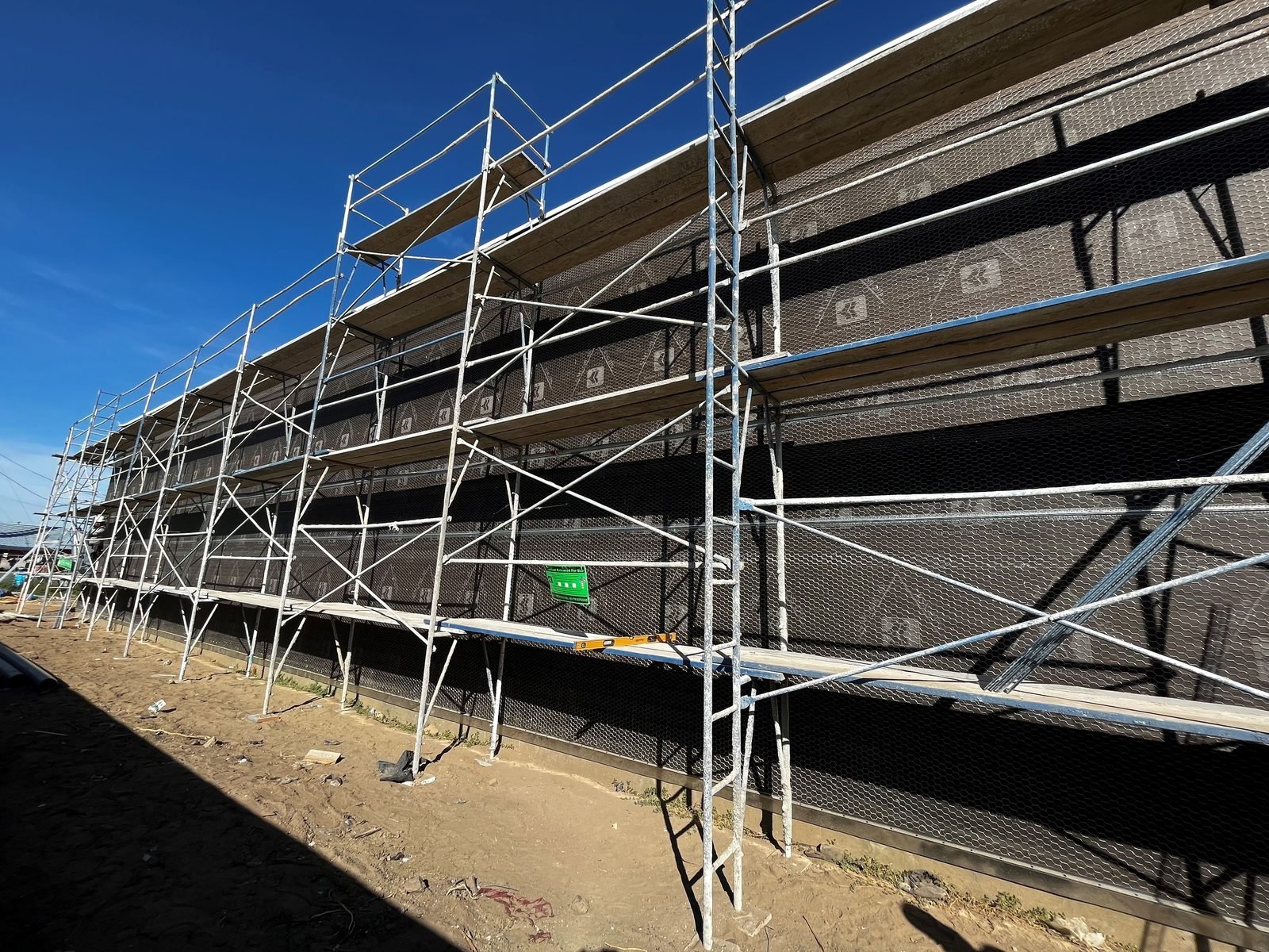 Plastering the elevation from full-height scaffold