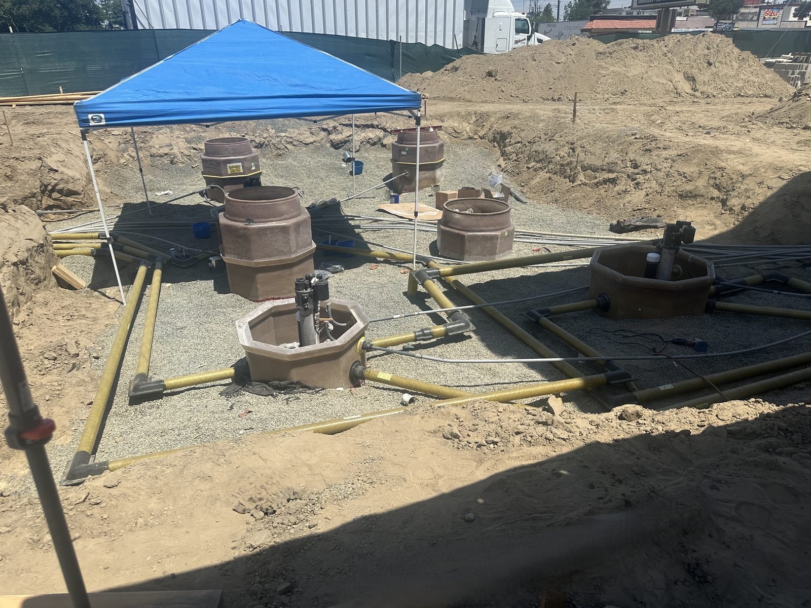 Tank excavation with sumps and piping set