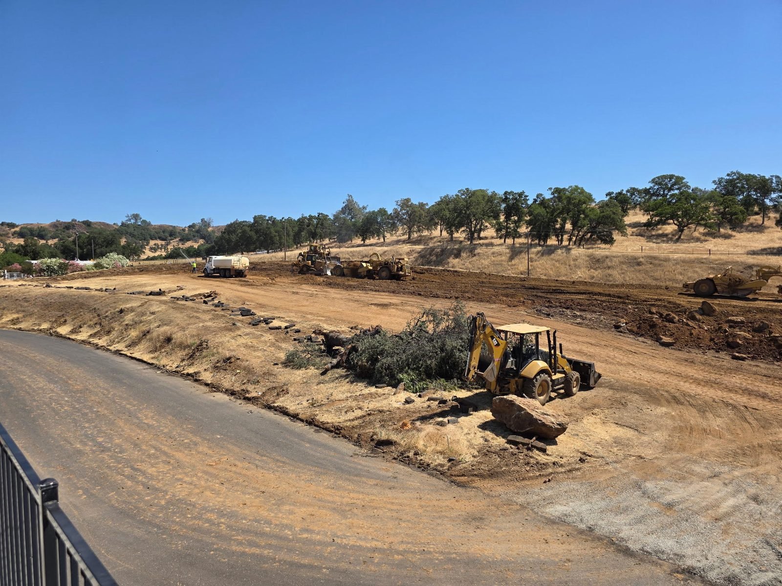 Building pad graded and access road cut in