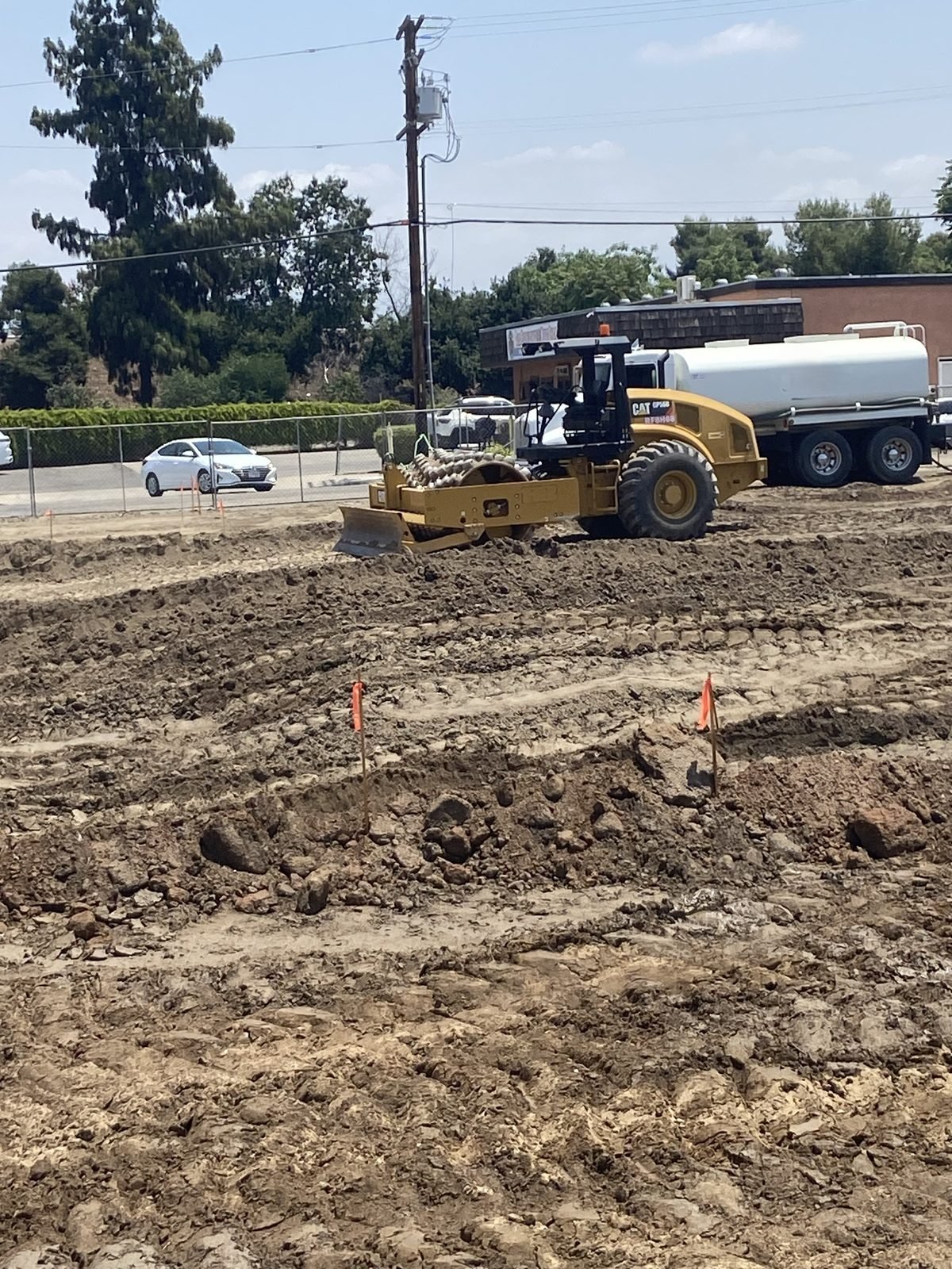 Loader clearing and moving material across the site