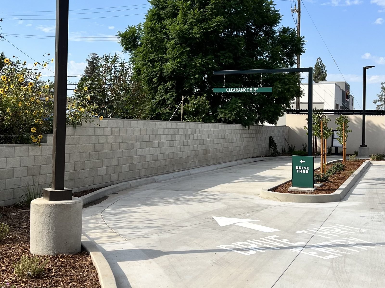 Finished drive lane with site lighting and signage