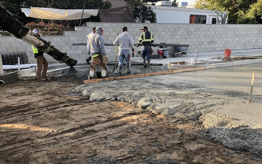 Crew placing and screeding a slab from the pump boom
