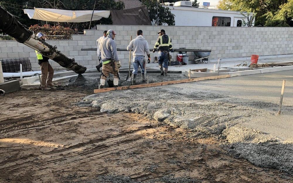 Crew placing and screeding a slab from the pump boom